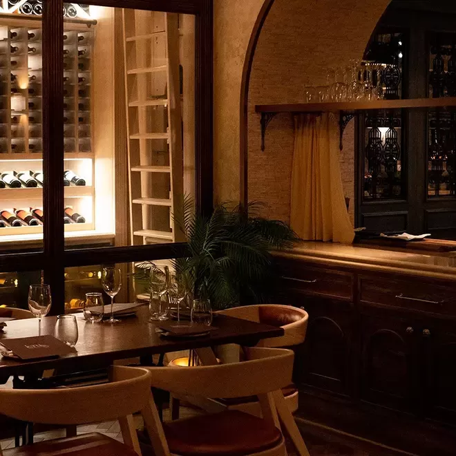 Luxury dining area interior with open wine cellar at Jeru, Mayfair, London