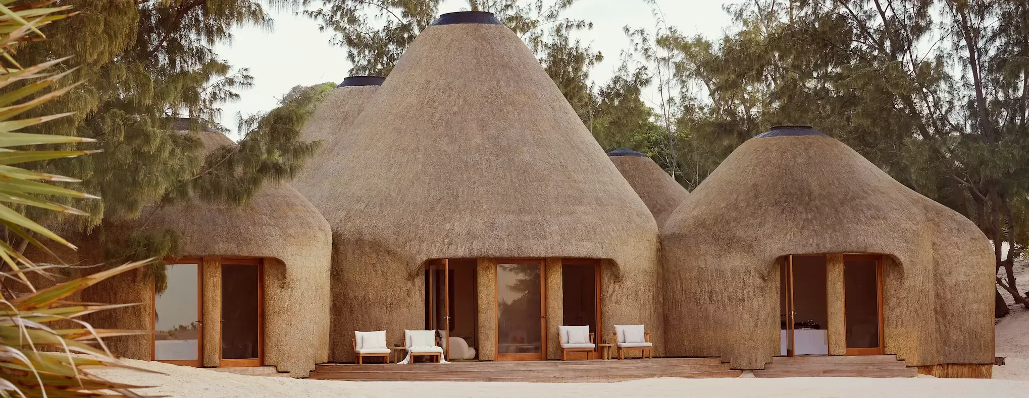 Exterior of Kisawa Sanctuary of straw rustic teepees on sand in Mozambique
