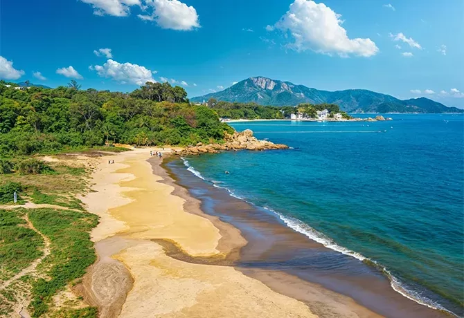 View of blue sea, sand and mountains beach at Cheung Sha Wan, Lantau, Hong Kong