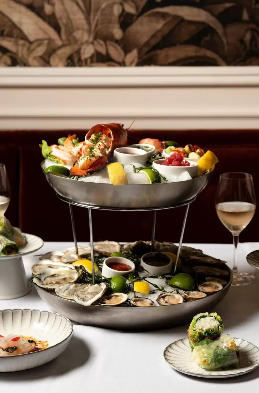 Two tiered sea food platter on ice served with side dishes at Soho House designed restaurant La Marchande, New York