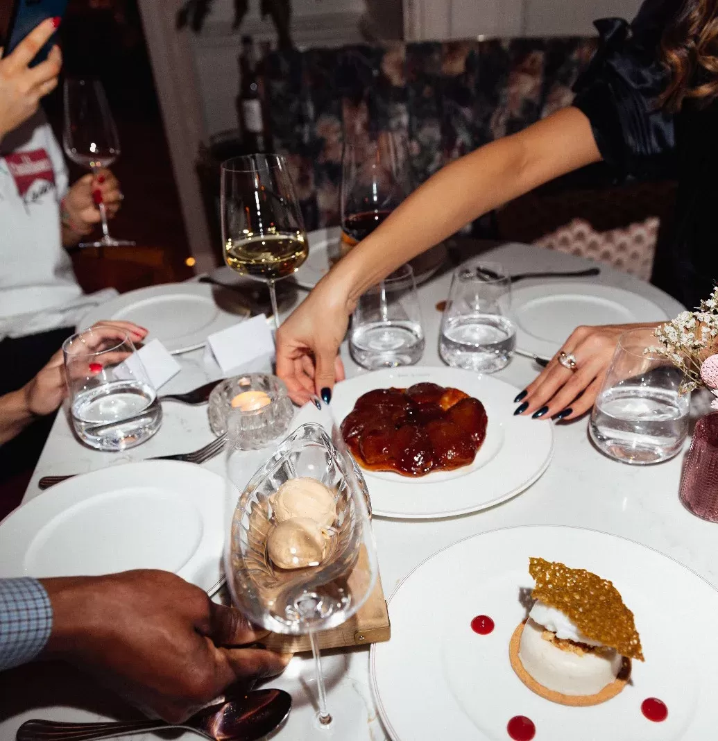People sharing Pear tatin on a dining table at The LaLee, London
