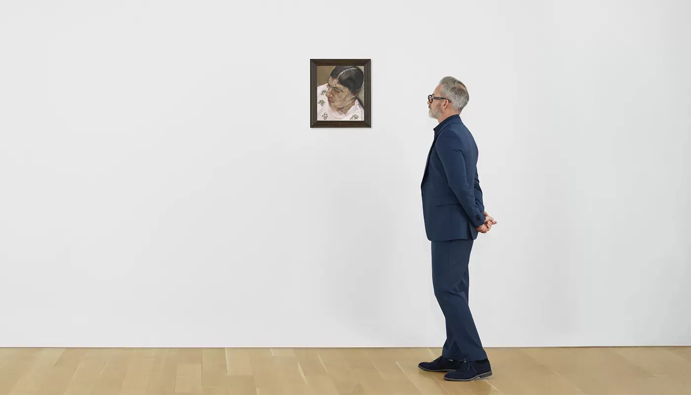 Man in gallery looking at Annabel Portrait III by Lucian Freud