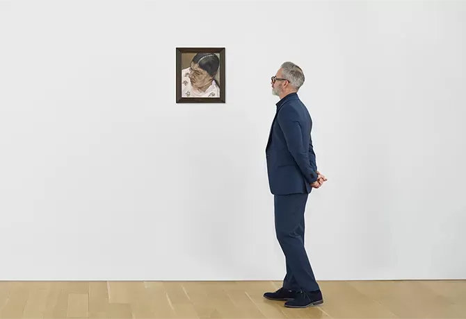 Man in gallery looking at Annabel Portrait III by Lucian Freud