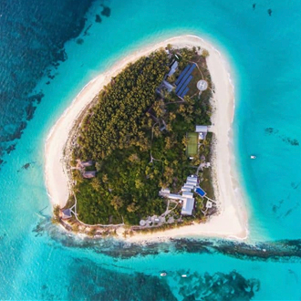 Birds eye view of Thanda Island, Tanzania surrounded by white sand and blue sea