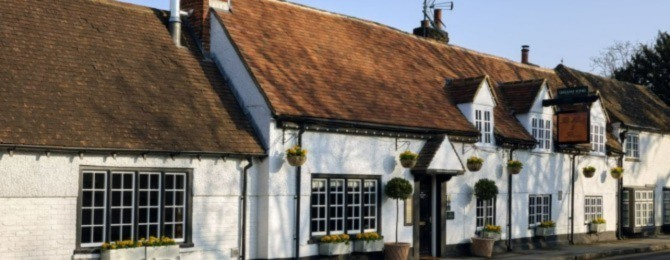 Outside white thatched cottage exterior of The Hand & Flowers, Bray