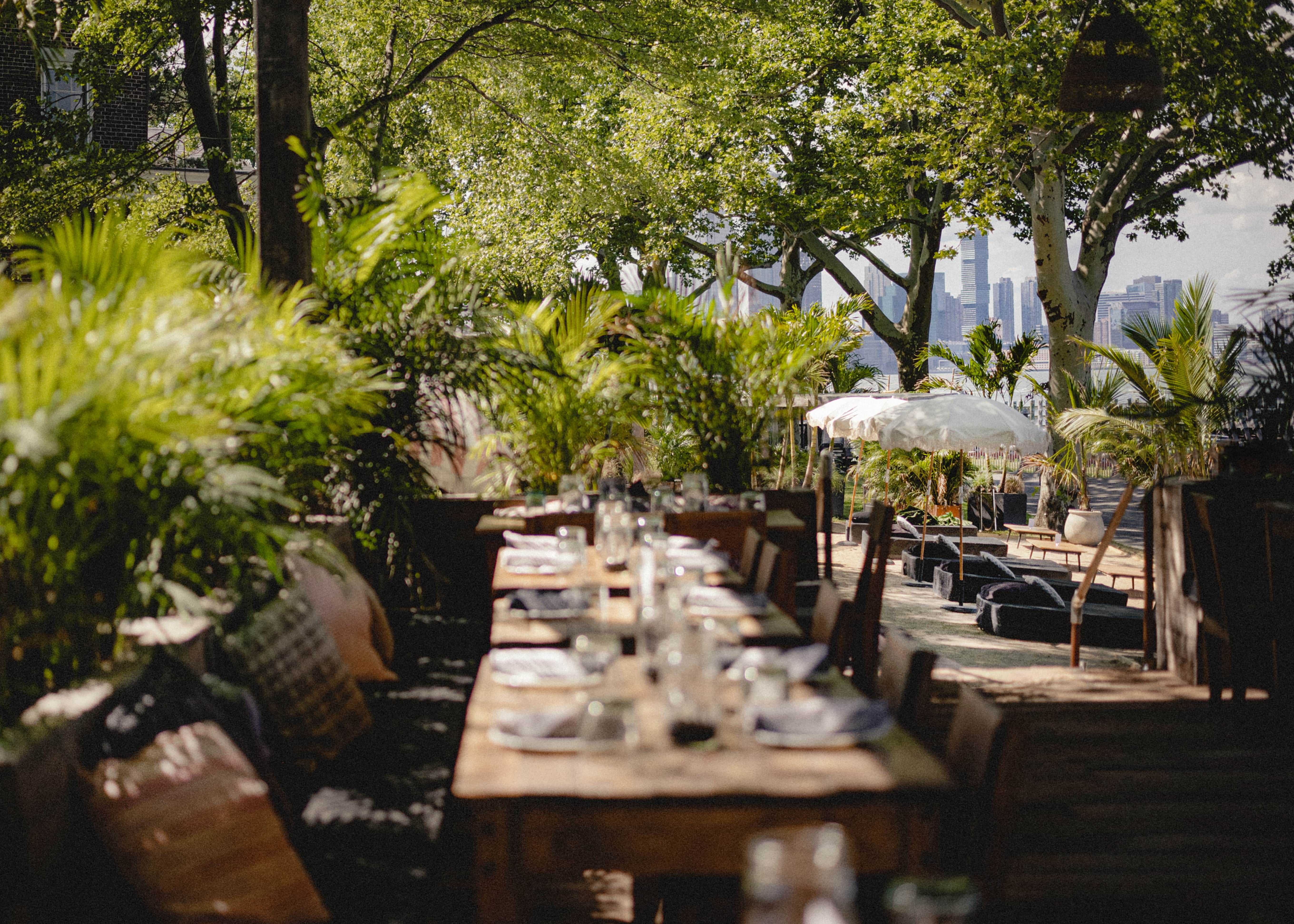 Rustic wooden outdoor table and chairs dining area surrounded by nature