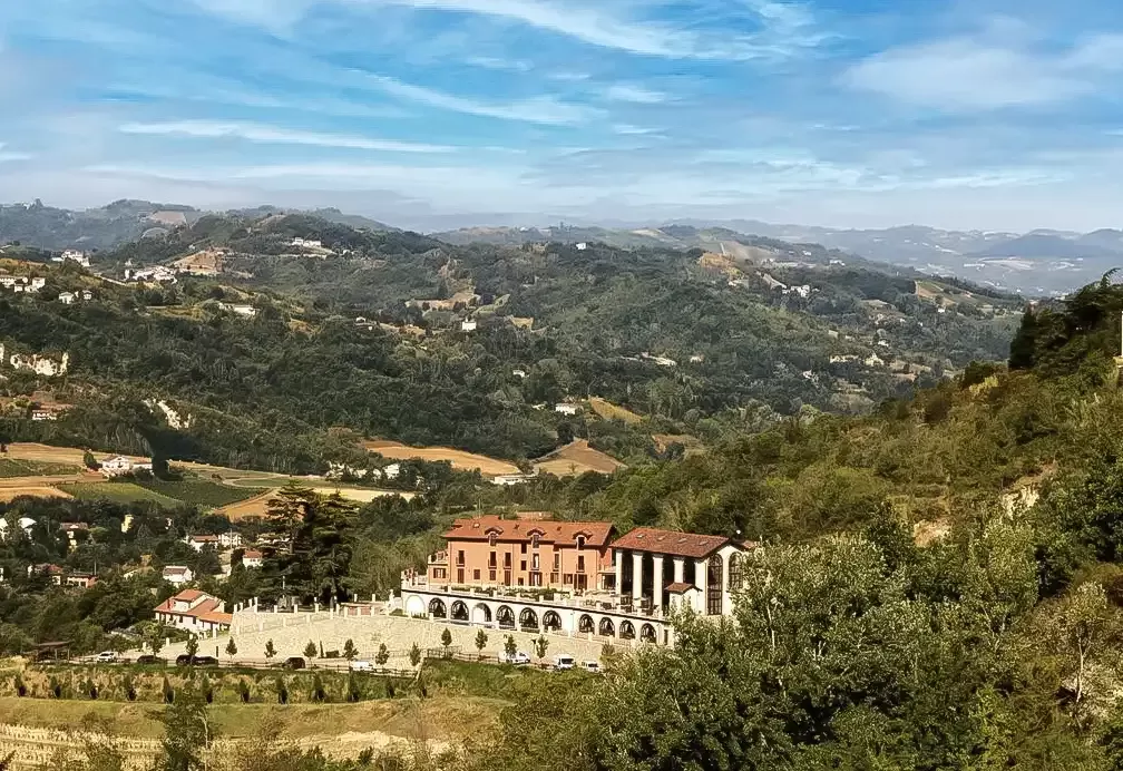 Exterior of grand 800-year-old farmhouse Nordelaia between the hilly mountains of Piedmont