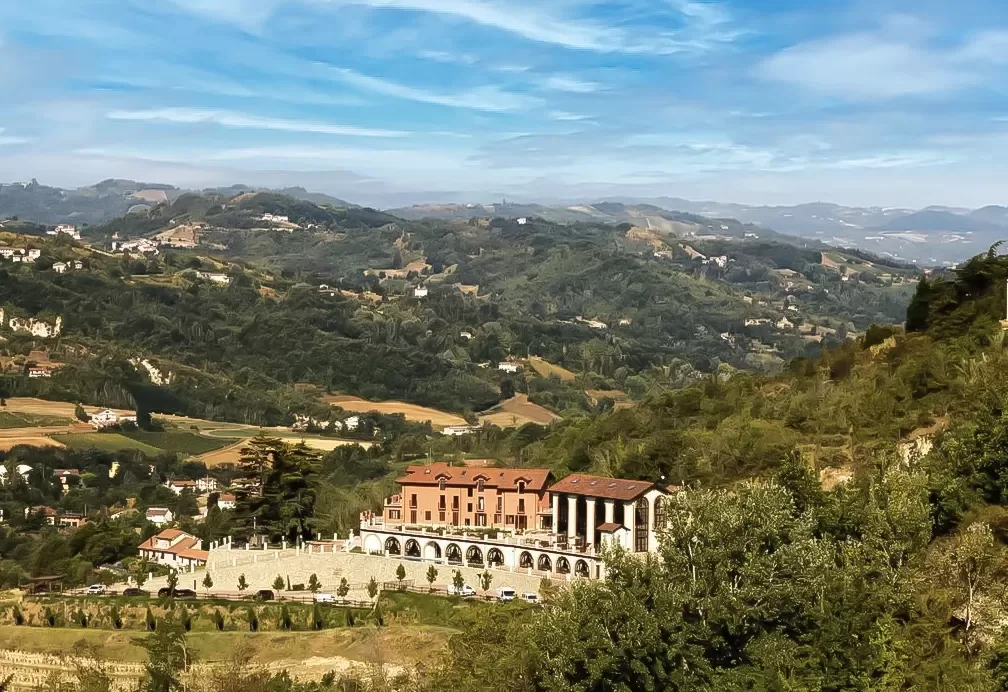 Exterior of grand 800-year-old farmhouse Nordelaia between the hilly mountains of Piedmont