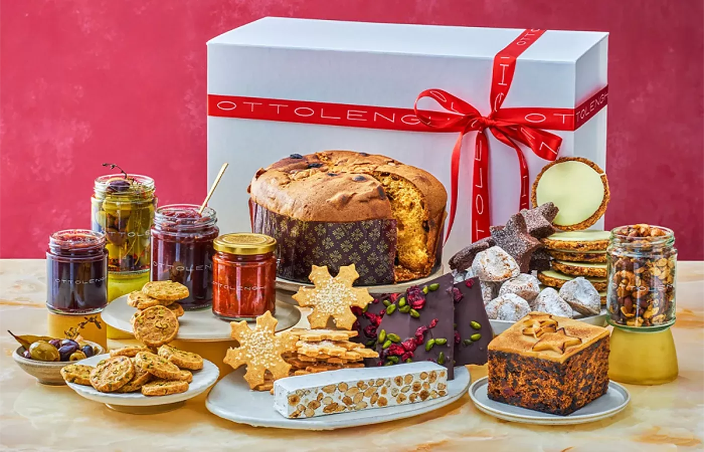 Food laid out on a table in front of Christmas hamper box from Ottolenghi Christmas Holiday Hamper
