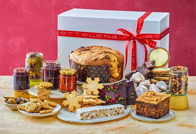 Food laid out on a table in front of Christmas hamper box from Ottolenghi Christmas Holiday Hamper