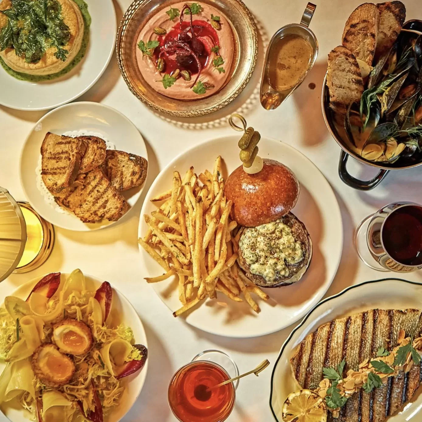 Birdseye view of selection of French inspired classic dishes served at Petite Patate Prospect Heights, Brooklyn, USA