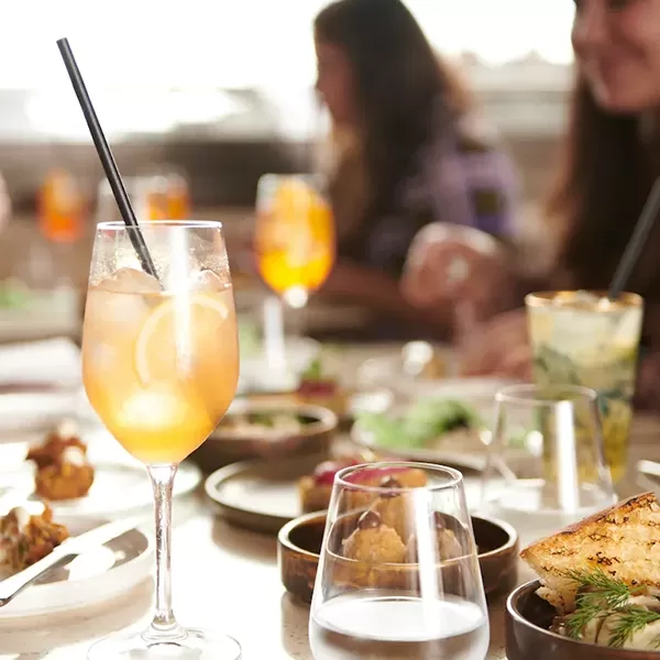 Food and cocktails on a table with a view at Piazza Terrace at the Royal Opera House, Covent Garden, London