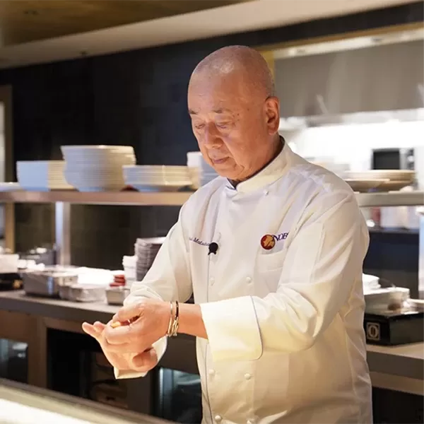 World-renowned chef Nobu Matsuhisa in chef's uniform cooking in Nobu kitchen