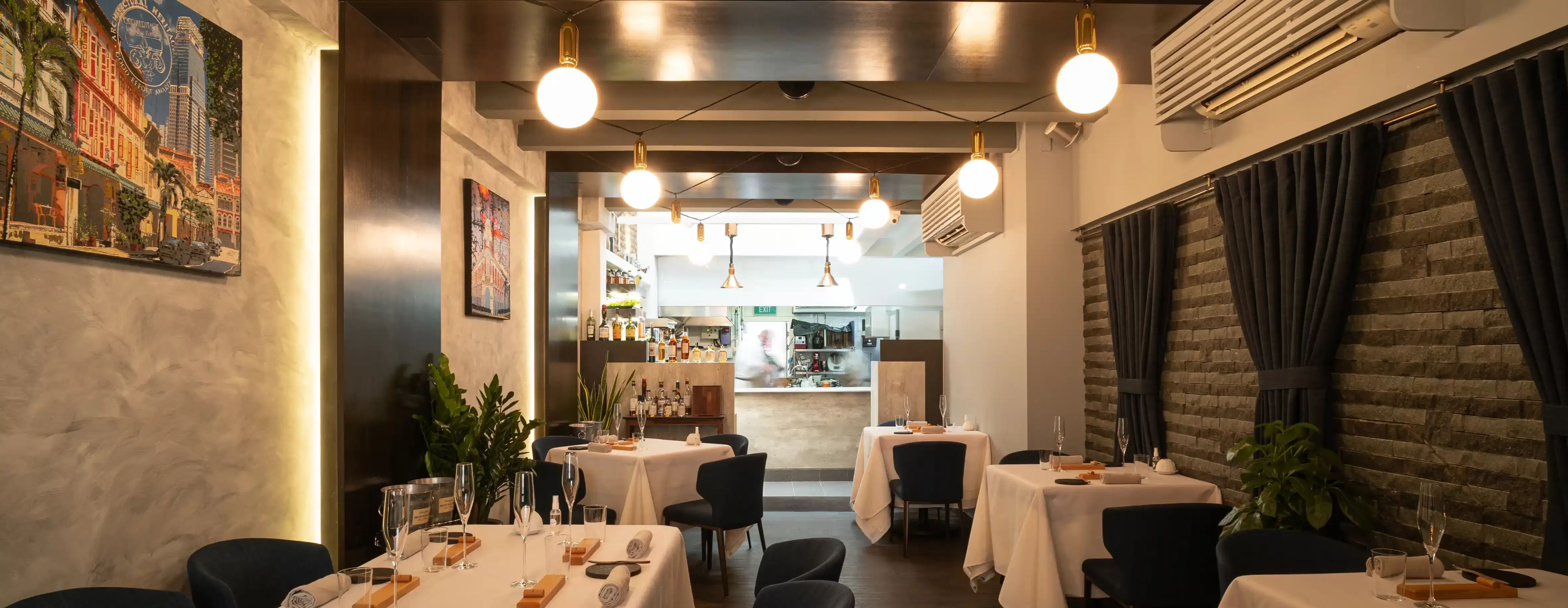 Interior narrow restaurants tables and blue chairs interior of Restaurant JAG, Singapore