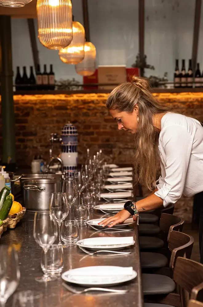 Waitress laying tables at Sabor, Mayfair, London
