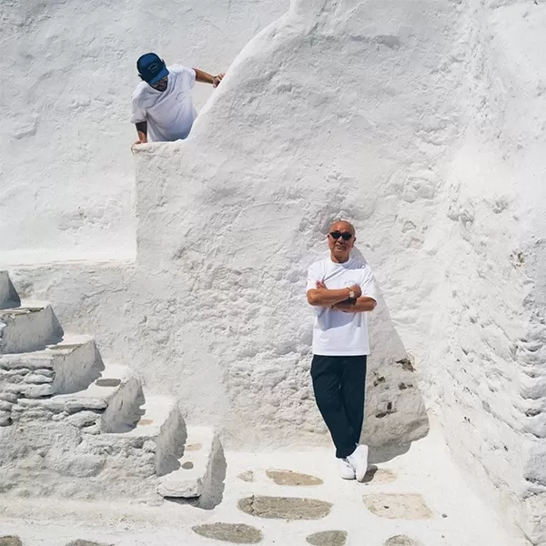 Nobu Matsuhisa posing in front of a white stone wall in Ibiza