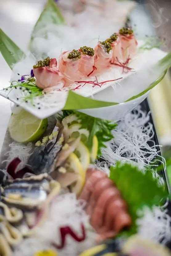 Beautifully displayed and garnished raw fish platter.