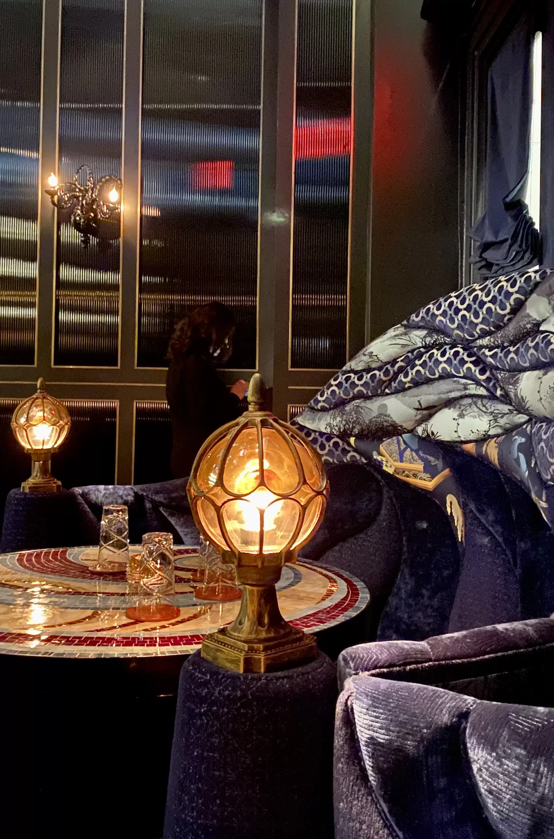 Luxurious wave-inspired private dining booth with patterned textile, patterned dining table and purple furniture at Shinji's, Flatiron, New York