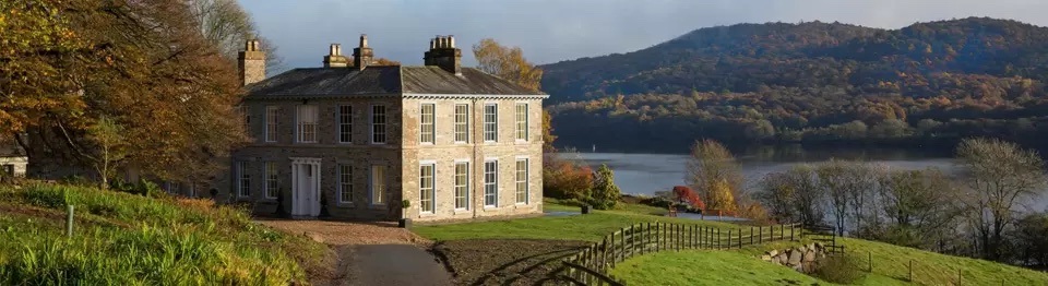 View of entrance to Silverhome Manor overlooking Lake and hills.