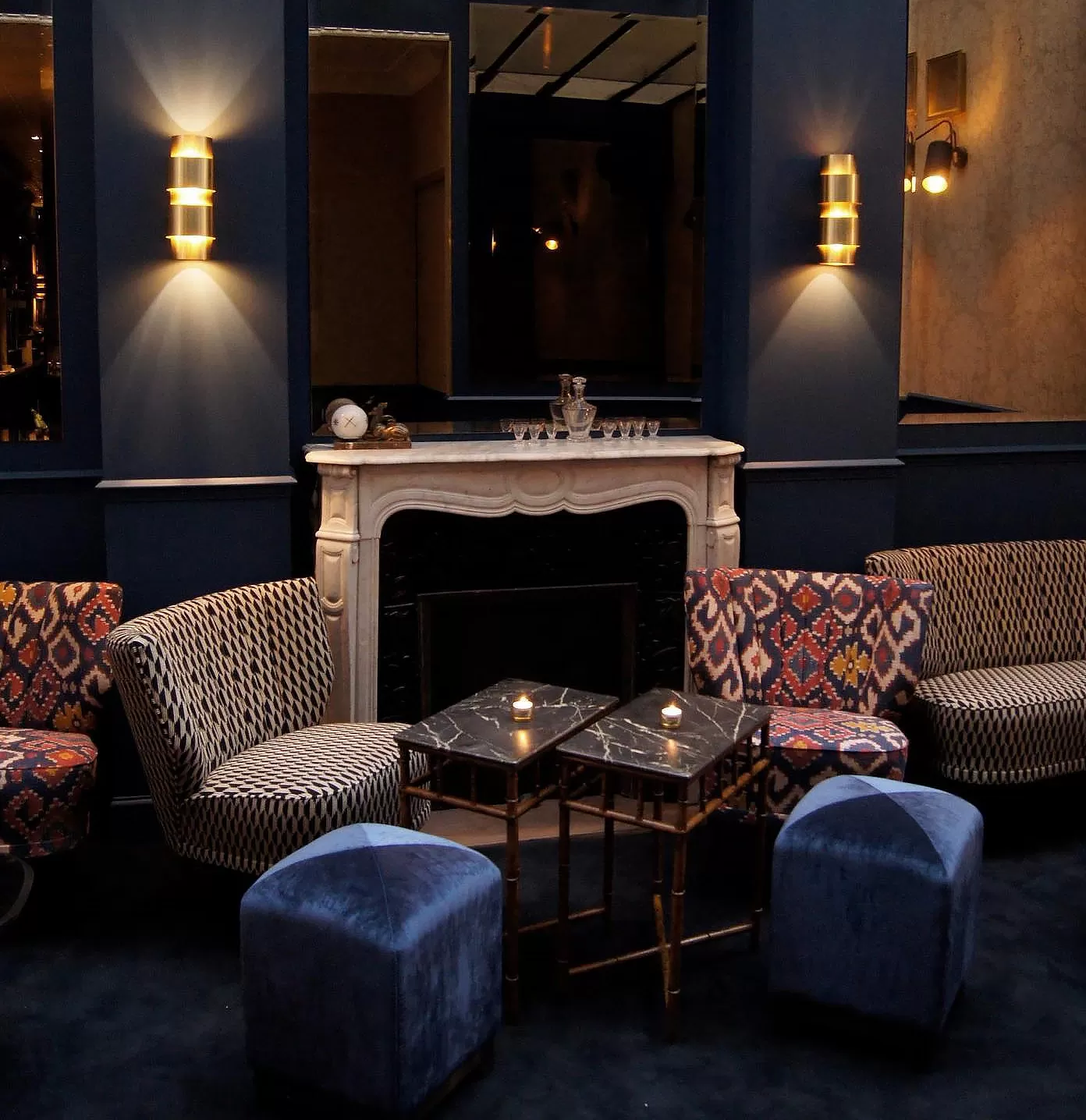 Dim-light lounge seating area with printed chairs at La Compagnie des Vins Surnaturels, Paris