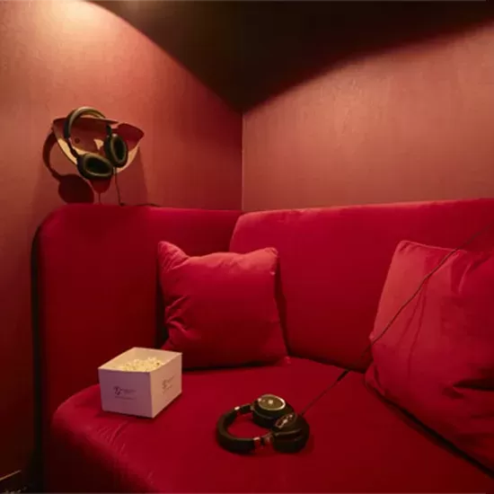 Red sofas in the cinema room at The Georgian House Hotel.