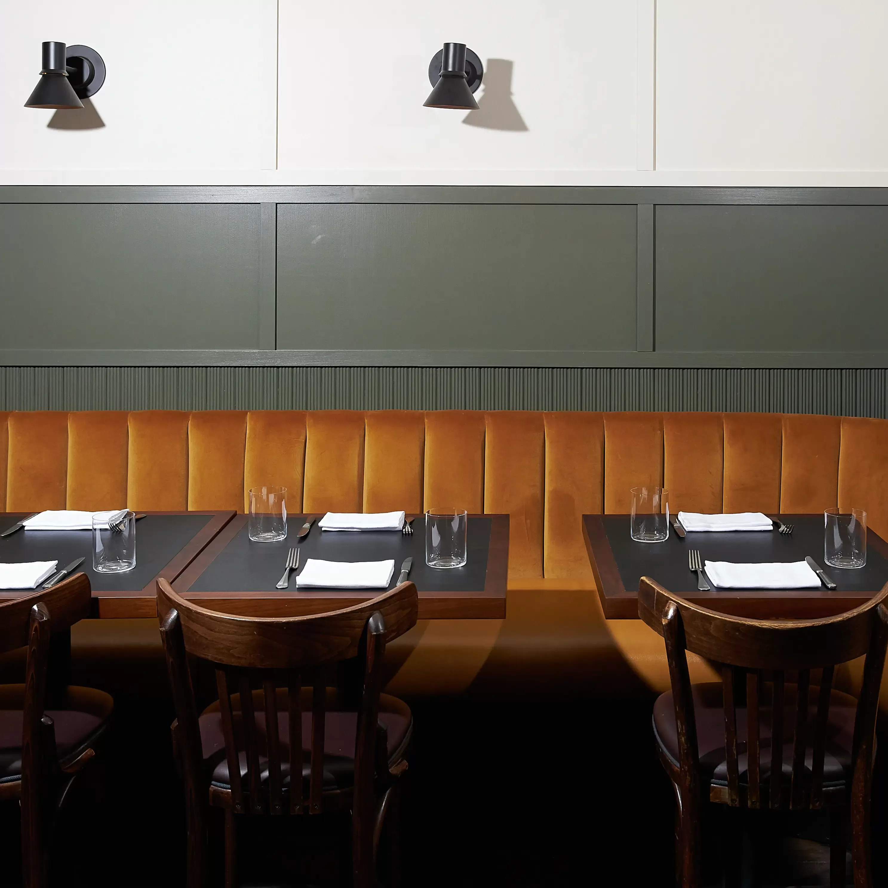 Dining booths with caramel sofa at The Noortwyck, West Village, New York