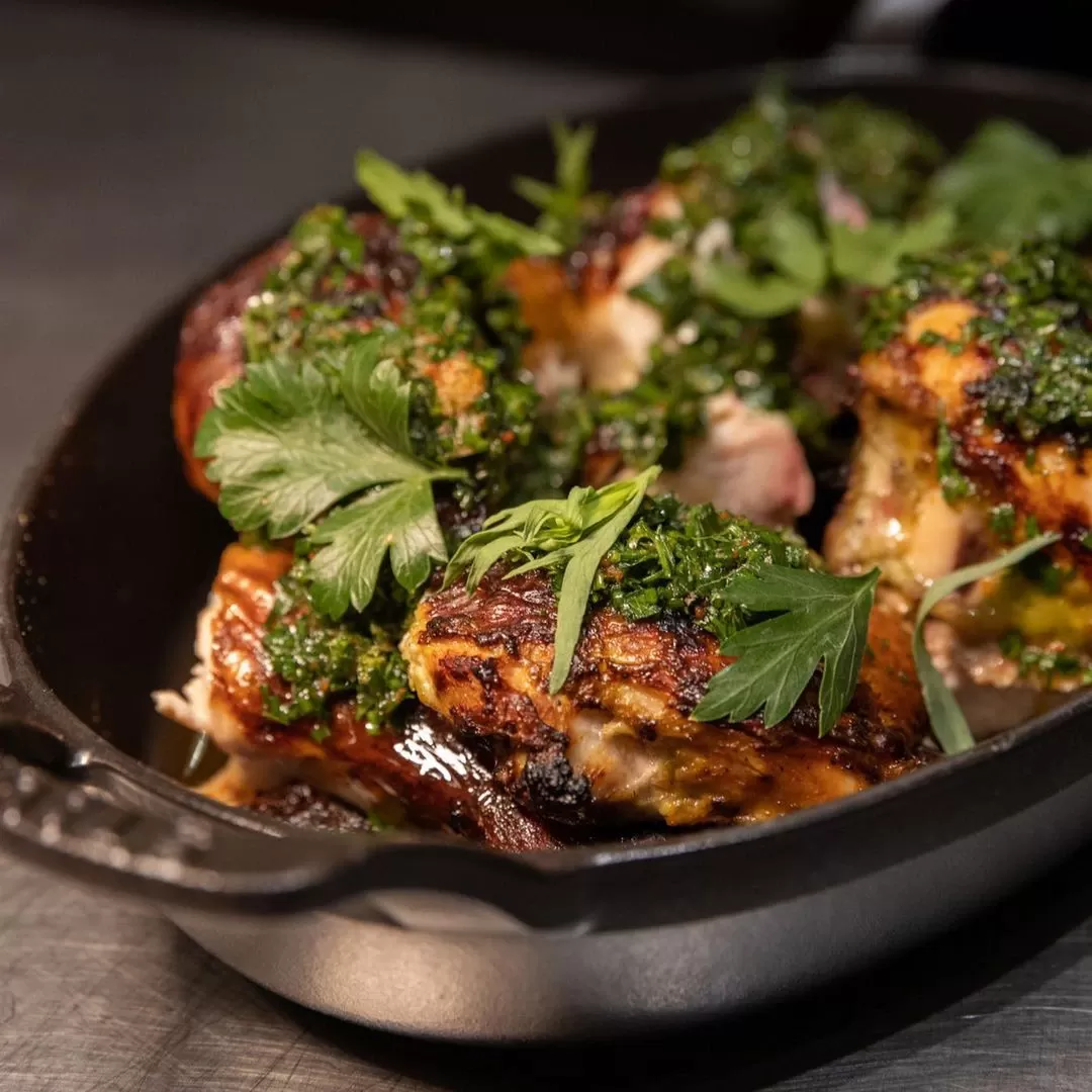Sharing roast chicken served in dish at The Noortwyck, West Village, New York