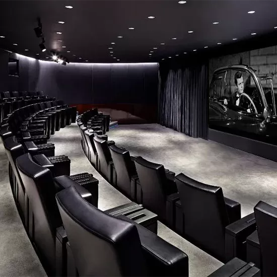 Rows of black leather cinema seats at The Screening Room at Bulgari.