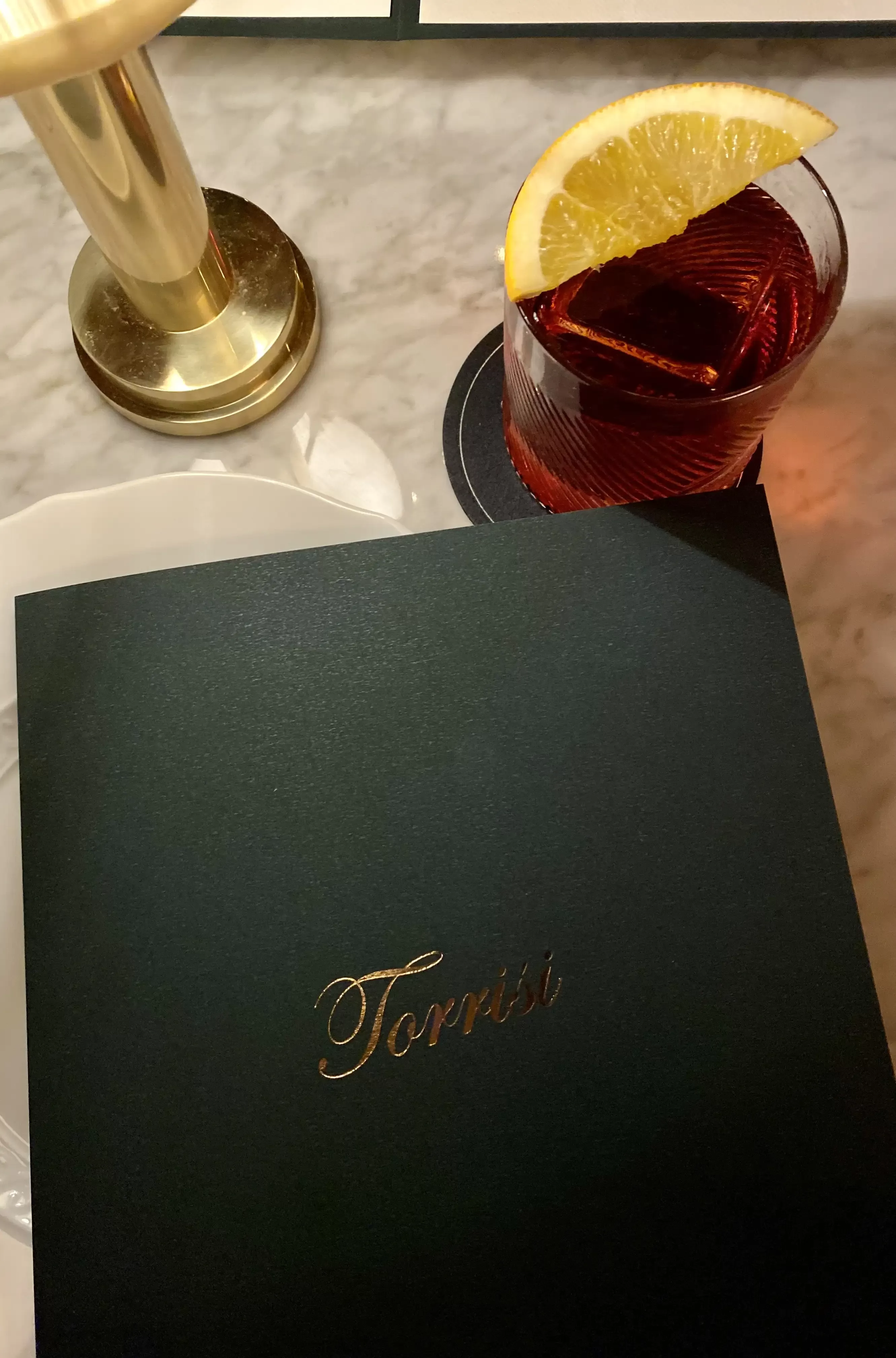 Cocktail served with brandd menu at Torrisi Bar & Restaurant, Little Italy, New York
