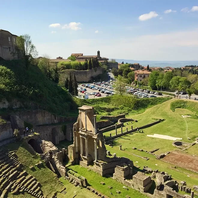 Birdseye view over Volterras Roman amphitheater on a summers day in Volterra, Tuscany, Italy