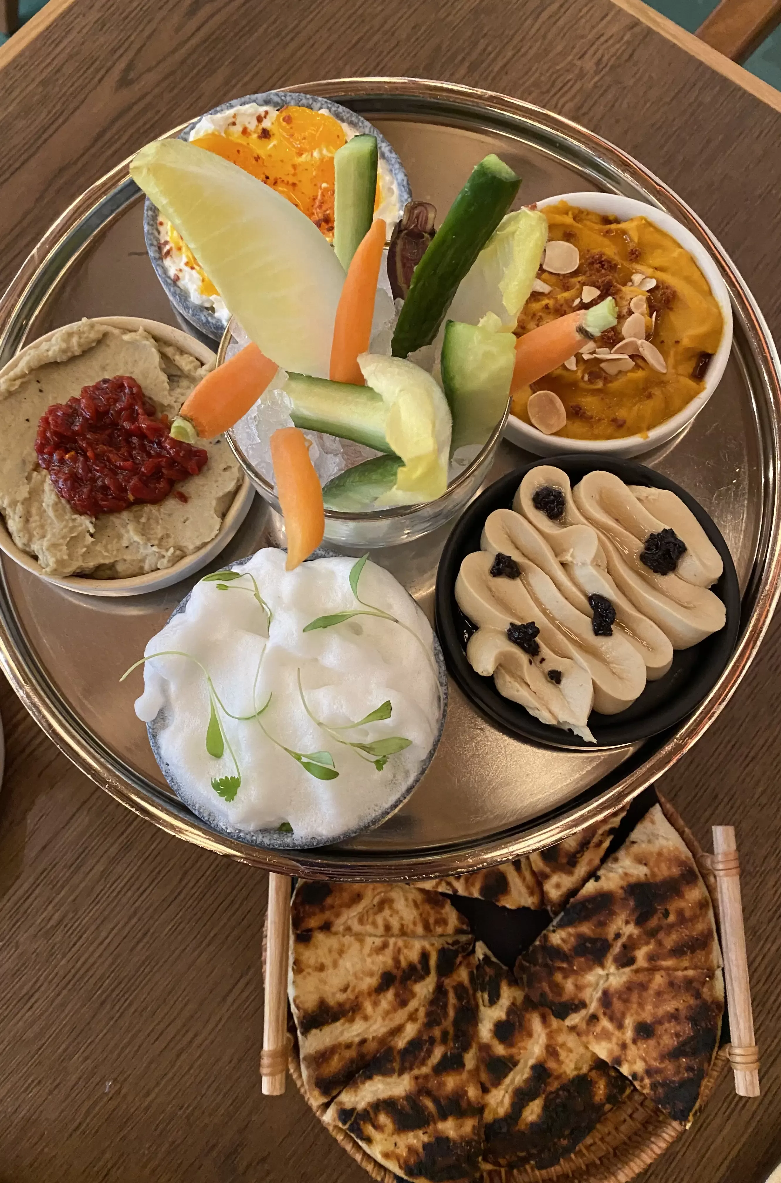 Sharing plate of Eastern Mediterranean style various dips, vegetables and bread at Zou Zou's, Hudson Yards, New York
