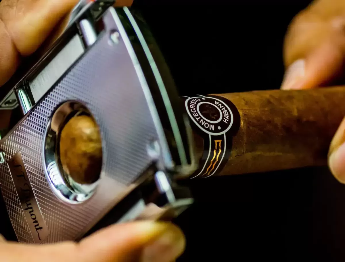 Person cutting a Cigar with tool a Marty's Chez Tabac shop, Toronto, Canada