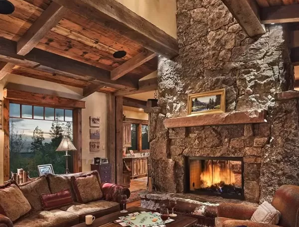 Luxurious cosy ski lodge interior with stone walls, wooden interior and wood burning fire