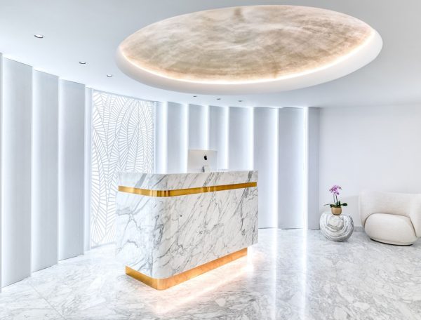 Grand circular shaped room with marble floor and marble and gold reception desk at the Matild Spa, Budapest