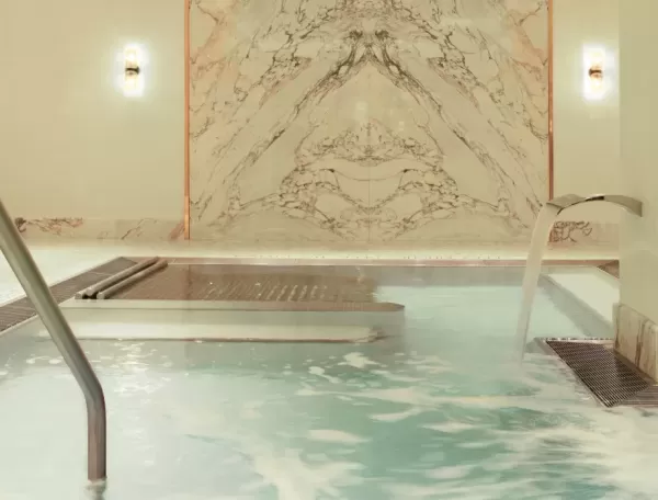 Luxury indoor spa pool with water fountain and spray jets at Spa Diane Barrière, New York