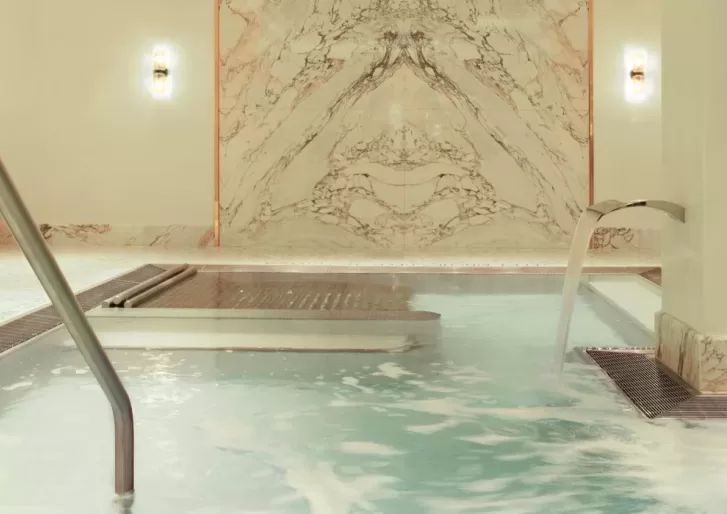 Luxury indoor spa pool with water fountain and spray jets at Spa Diane Barrière, New York