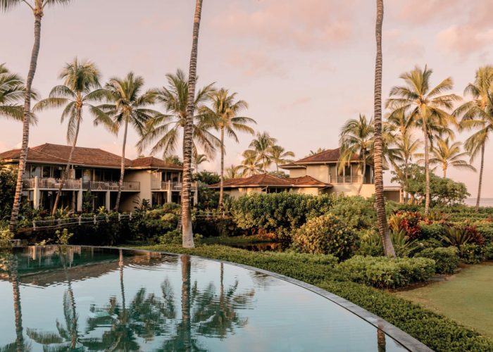 Palm trees and lake on the grounds of The For Seasons Resort, Hualalai, Hawaii