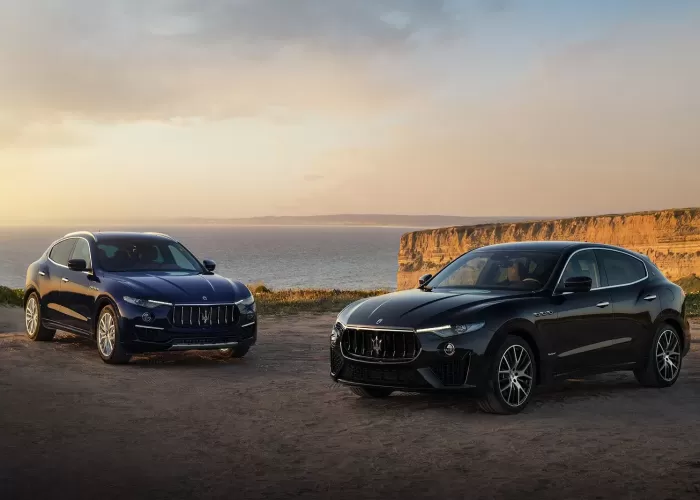 Two Maserati Levante Hybrid parked on top of a cliff