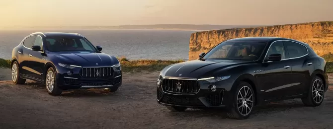 Two Maserati Levante Hybrid parked on top of a cliff
