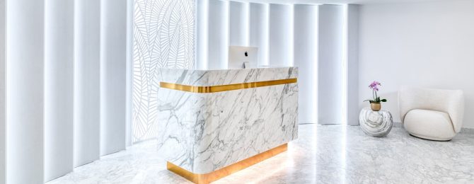 Grand circular shaped room with marble floor and marble and gold reception desk at the Matild Spa, Budapest
