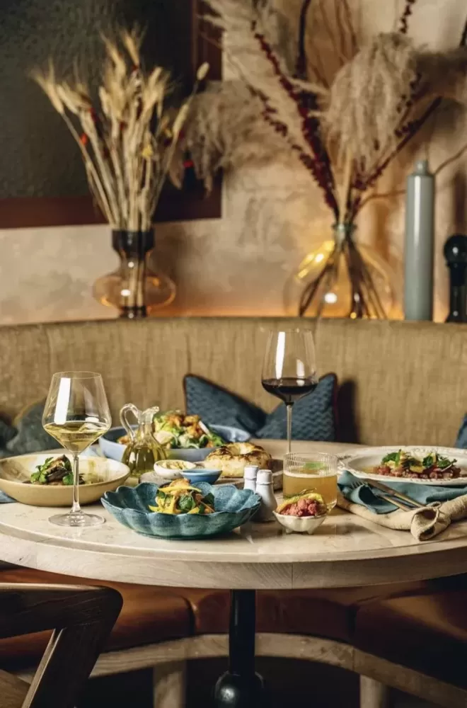 Table full of food and wine at restaurant Jeru