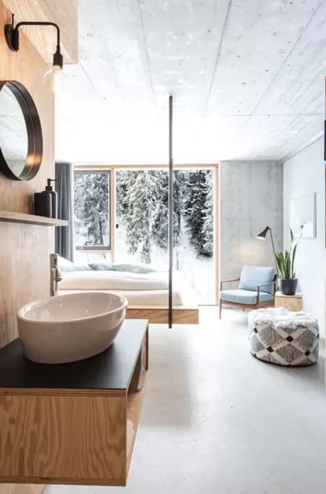 Interior luxury hotel suite with sink and view of snowy outdoors at Riders Hotel, Laax, Switzerland