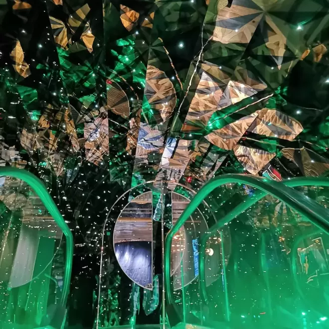 Top of escalator to green effect lightening on the roof