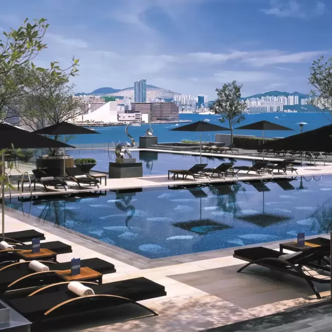 Outside pool and sunbeds overlooking Hong Kong city