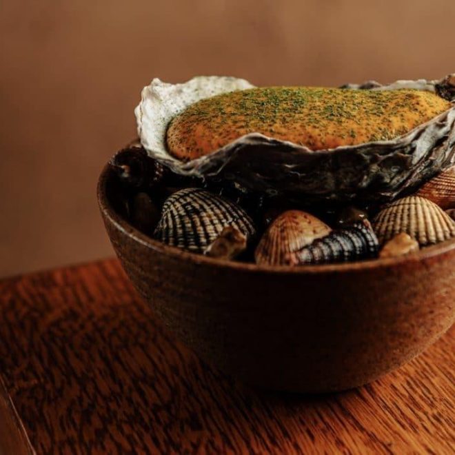 Gambian oysters served in wooden bowl at Akoko