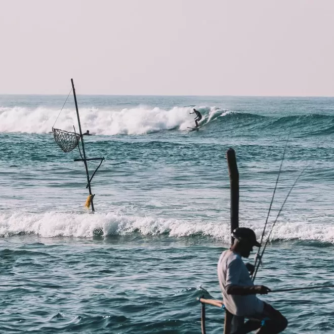 Man sat watching the waves at sea in Norway, Lapoint