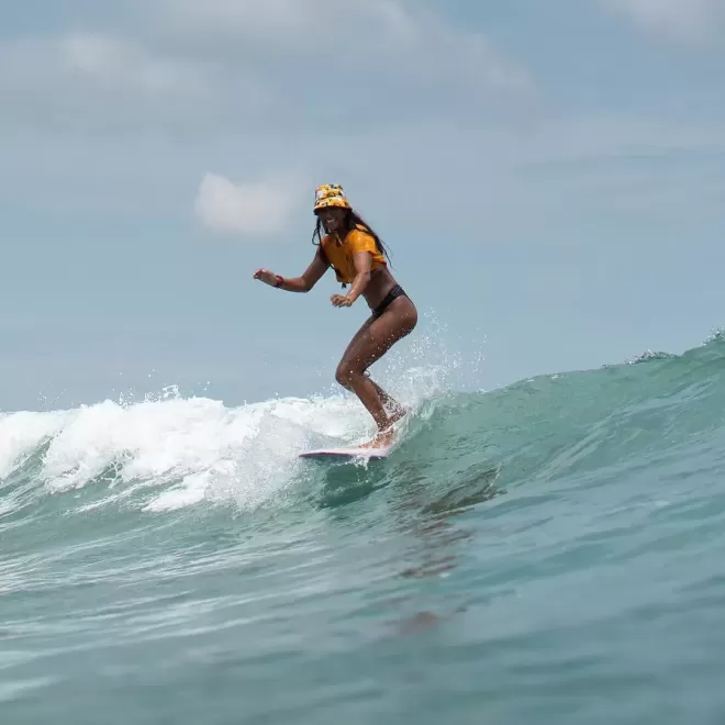 Women surfing a wave in Norway, Lapoint