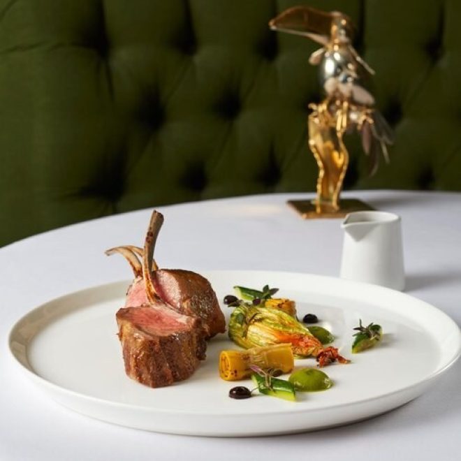 Lamb cutlet and finely displayed garnish on round white place