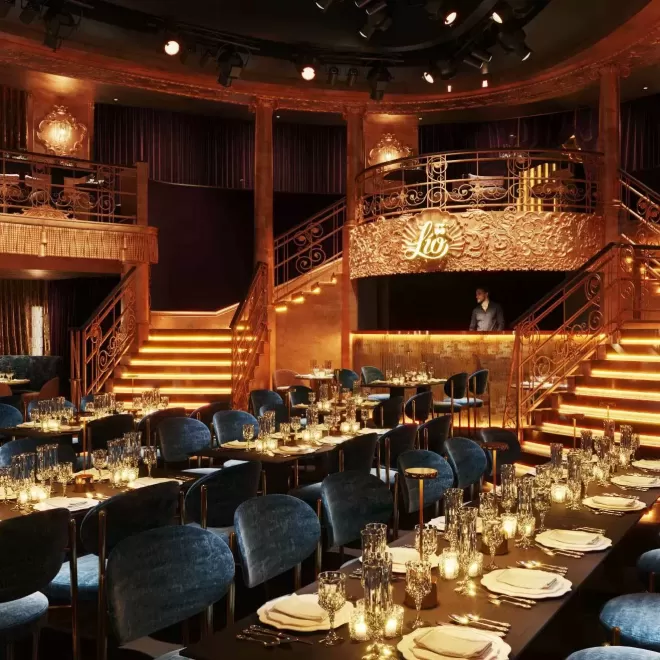 Grand interior gold dining area with balcony and blue chairs at Lio