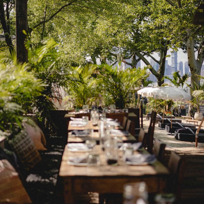 Rustic wooden outdoor table and chairs dining area surrounded by nature